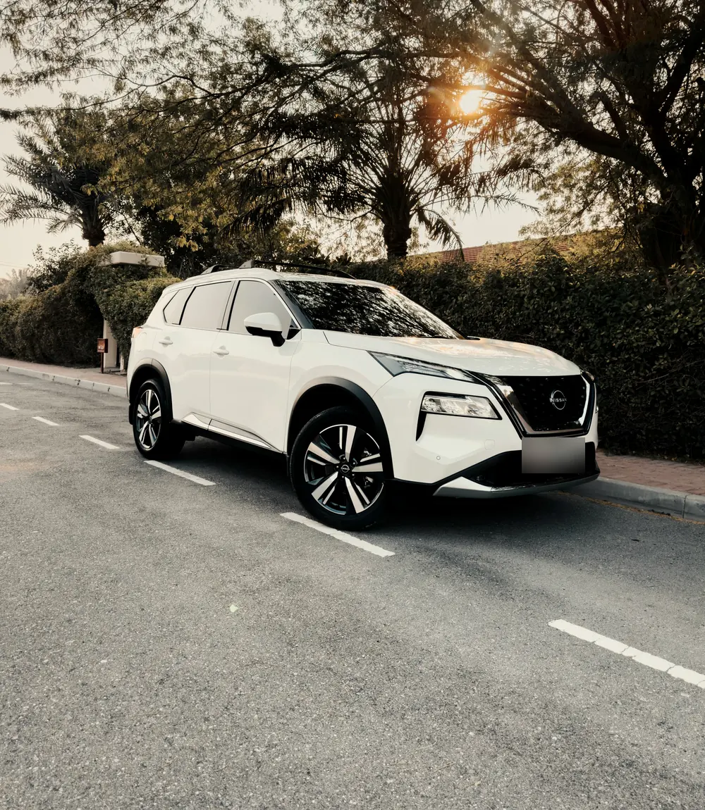 White Nissan Rogue SUV parked on a quiet street