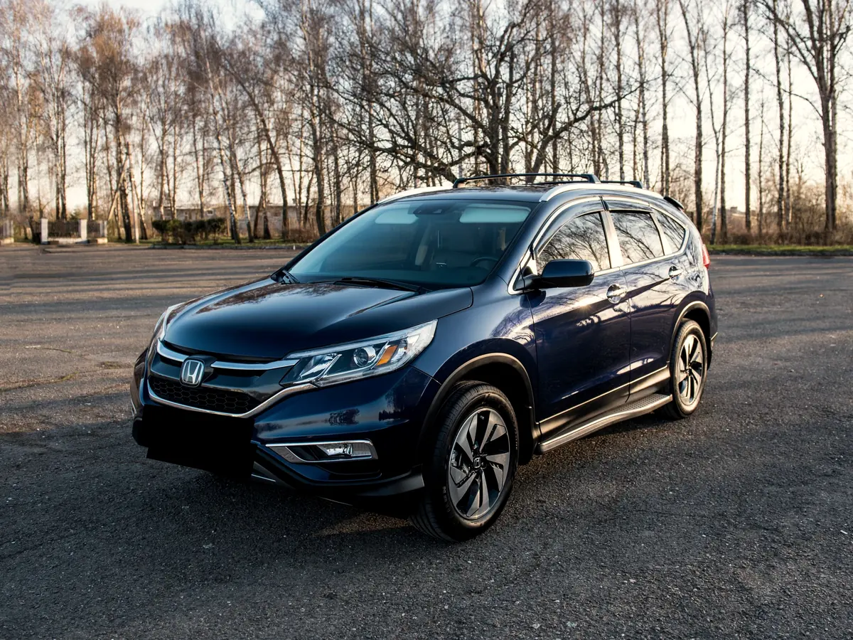 Blue Honda CR-V SUV in a parking lot