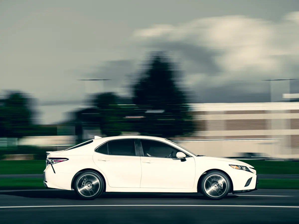 White Toyota Camry sedan on the road